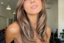 beautiful long light brown hair with lighter accents, chin bangs and curved ends is a beautiful and very summer-like idea