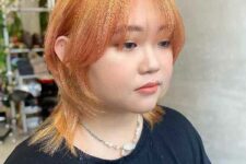 bold orange octopus hair with central part and face-framing locks plus wispy bangs is a low-maintenance idea for everyone