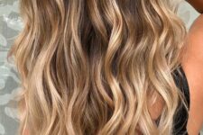 dark brown hair with honey blonde balayage and beachy waves looks eye-catchy, contrasting and more relaxed