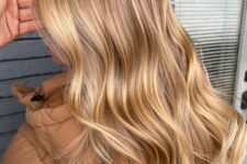 fabulous long soft brown hair with honey blonde balayage and waves looks very stylish and very beautiful