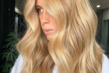 long and chic gold blonde wavy hair with central part is a very chic and beautiful idea to rock