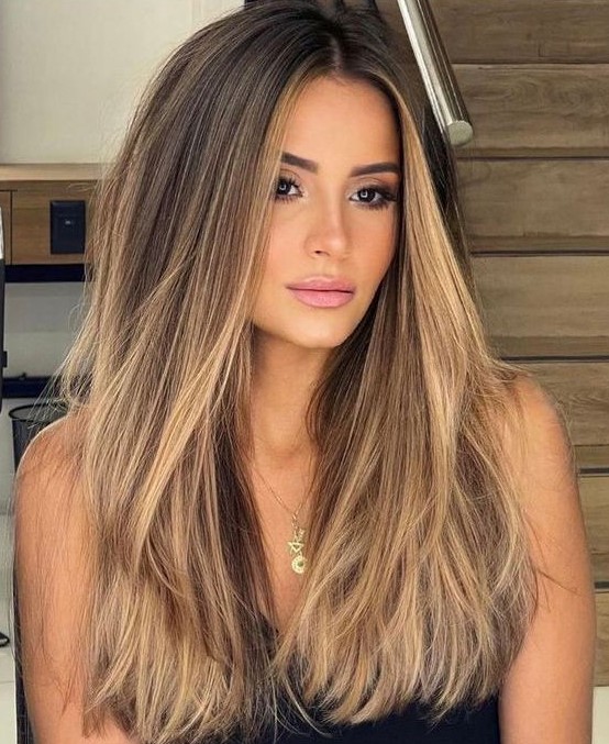 long dark brown hair with gold blonde balayage and babylights is a beautiful solution with much dimension and a beachy feel