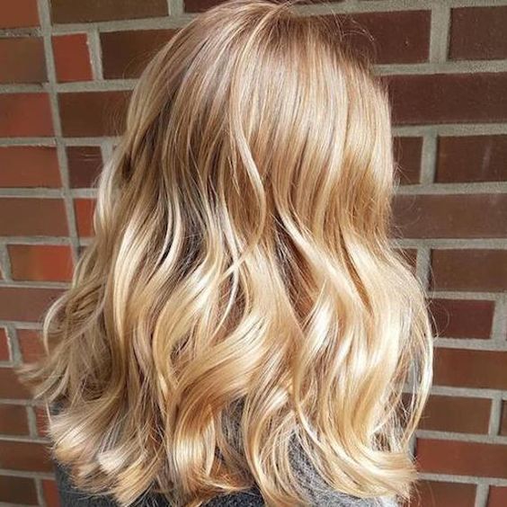 long wavy gold blonde locks are a classic idea for everyone, this shade of blonde never goes out of style
