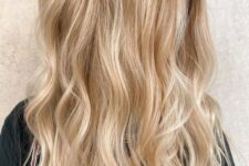 lovely blonde hair with a darker root, with gold and icy blonde balayage and waves loosk truly beach-like and cool