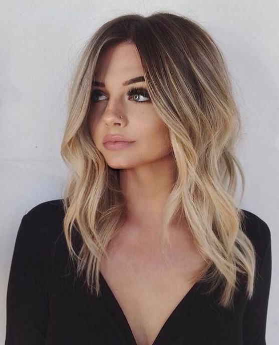 lovely rooty gold blonde hair with slight waves is a very stylish and trendy idea to wear in summer