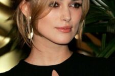 Keira Knightley wearing brunette hair with honey and blonde balayage, with face-framing layers for a super refined and chic look