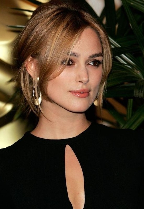 Keira Knightley wearing brunette hair with honey and blonde balayage, with face framing layers for a super refined and chic look