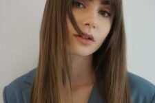 Lily Collins wearing long brunette hair with classic fringe bangs looks very chic and very stylish