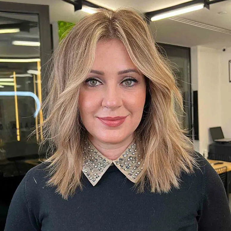 a beautiful choppy haircut with balayage, soft curtain bangs for an effortless look without any bulky movement