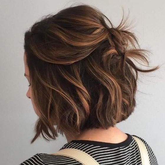 a black bob done with caramel balayage, with a lot of volume, waves is a lovely idea to rock