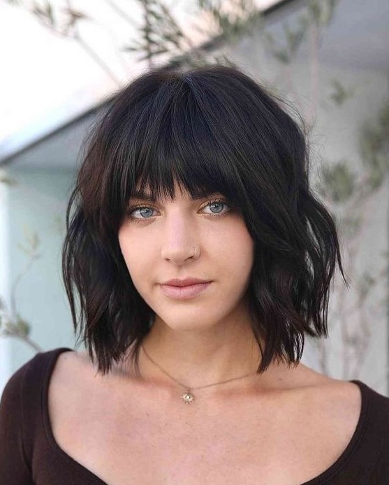 a black choppy bob with fringe bangs and waves is a lovely idea to rock and it looks fresh, bold and rebellious