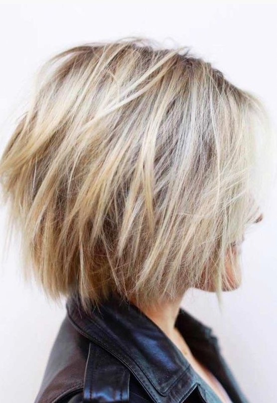 a blonde feathered bob with layers and balayage is a fresh and modern idea to rock