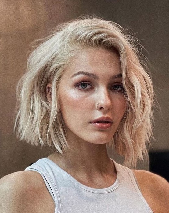 a blonde shaggy bob with textured hair is a hot and bold hair idea to try right now