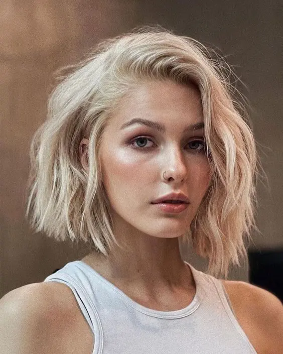 a blonde shaggy bob with textured hair is a hot and bold hair idea to try right now