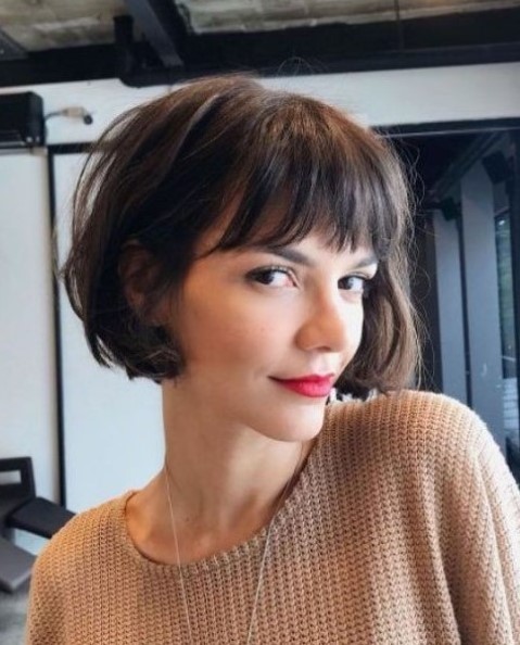 a brown boy bob with fringe bangs and waves is a classic French hairstyle that many stylish Parisian girls have tried