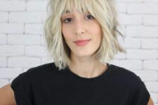 a cold blonde shaggy medium bob with a fringe and cool and lovely texture looks grunge-like