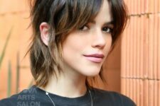 a dark brunette tucked shaggy bob with curtain bangs, caramel highlights and a bit of messy dimension is wow