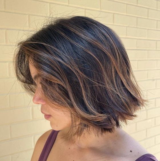 a dark textural bob with caramel balayage and babylights looks dimensional, voluminous and very chic