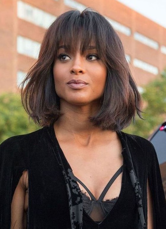 a fantastic deep brown long bob with texture and overgrown frigne bangs to make a girlish statement
