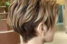 a long layered pixie with golden blonde and caramel highlights looks dimensional, textured and beautiful