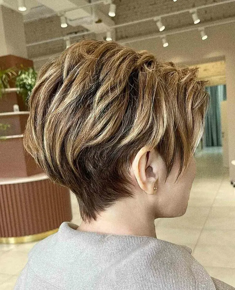 a long layered pixie with golden blonde and caramel highlights looks dimensional, textured and beautiful