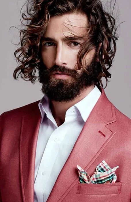 a long wavy hairstyle with a lot of movement and volume plus a full beard are an elegant idea, and if you have curls, it's even easier