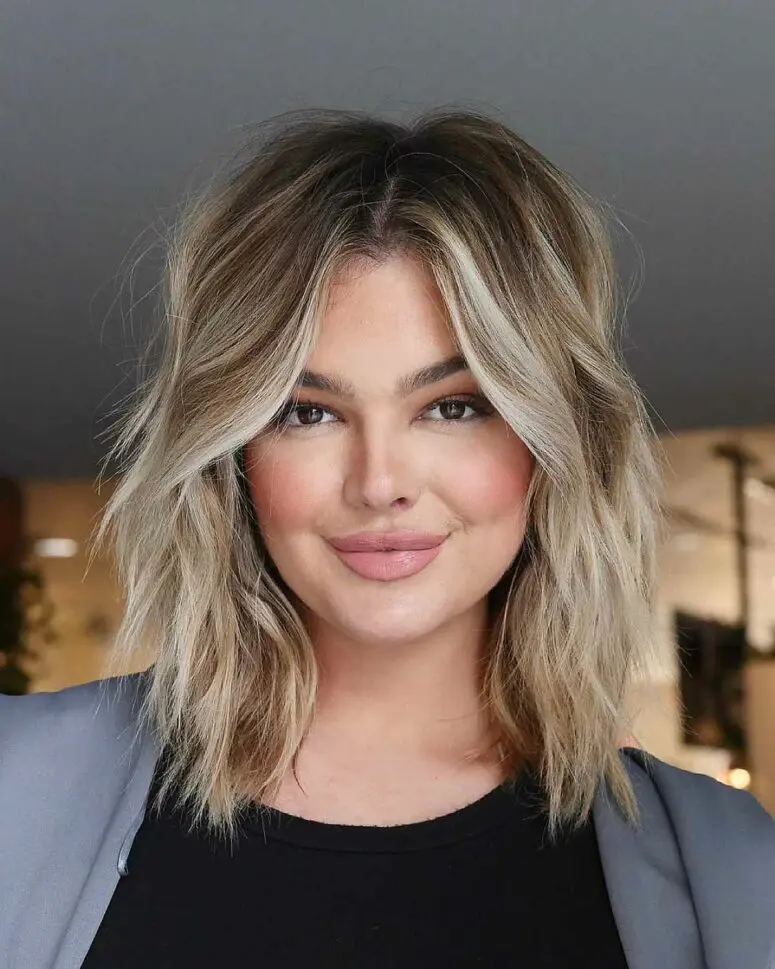 a medium layered and choppy haircut with blonde balayage and waves is a very cool and lovely idea