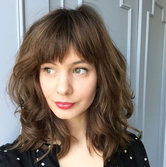 a medium length haircut with a fringe bang is a chic and girlish idea