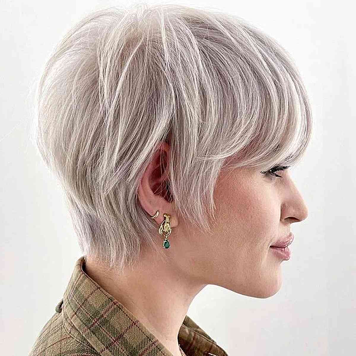 A platinum toned layered long pixie cut requires only a blow dry for a beautiful and stylish look