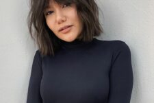 a shaggy dark brunette bob with curtain Bardot bangs and a lot of texture is amazing to wear now