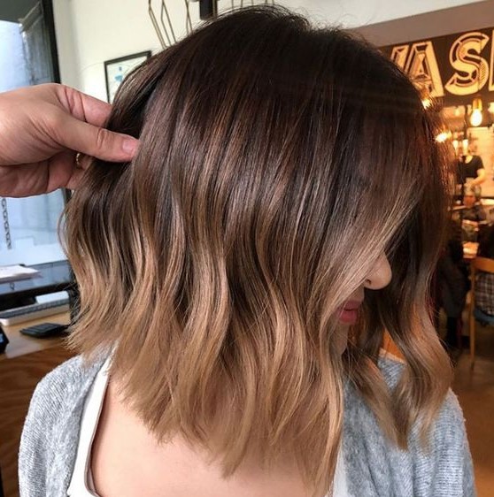 a stylish dark brunette long bob with an ombre effect with light brunette and waves is a very summer-like idea