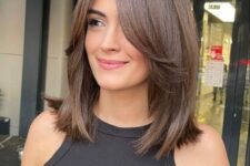 a super cool brunette medium length haircut with face-framing layers looks gorgeous and won’t be hard to maintain