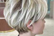 a super cool icy blonde layered pixie bob with darker root is a cool idea to get volume, movement and texture at the same time