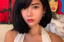 an asymmetrical black bob with side parting and side bangs is a fresh idea if you want to make your usual bob more eye-catchy