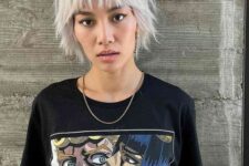 an icy blonde shaggy short bob with a fringe and a lot of texture looks very grunge-like