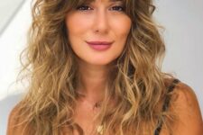 beautiful long wavy hair with gold blonde balayage and messy Bardot bangs is a cool and chic idea to try