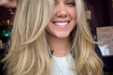 fab long blonde hair cut in layers including face-framing ones, with central part, looks amazing