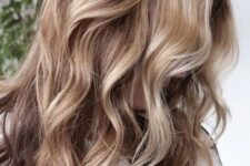 light brunette hair with blonde balayage and waves looks relaxed, chic and beach-inspired