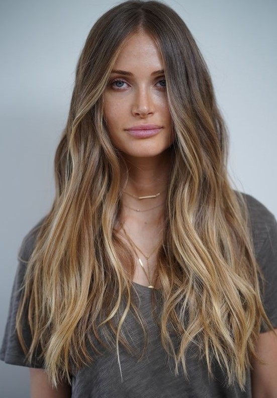 light brunette hair with long honey blonde highlights and waves is a cool idea to wear in summer