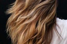 long and dimensional brunette hair with blonde balayage and beach waves is a very catchy idea to rock