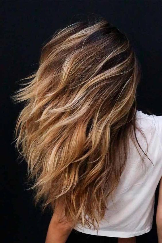 long and dimensional brunette hair with blonde balayage and beach waves is a very catchy idea to rock
