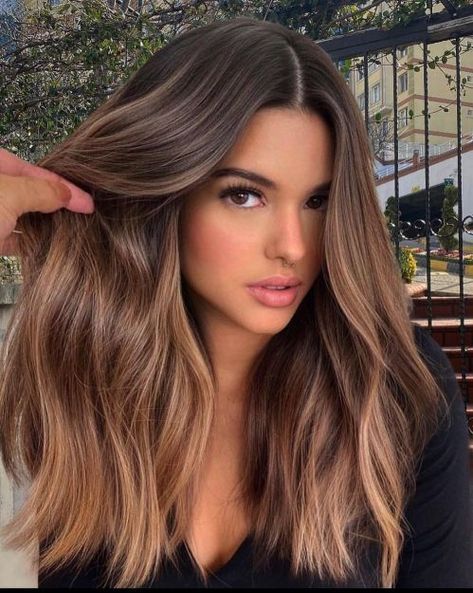 long and wavy dark hair with a volume and super delicate and neutral caramel balayage is a gorgeous idea to rock