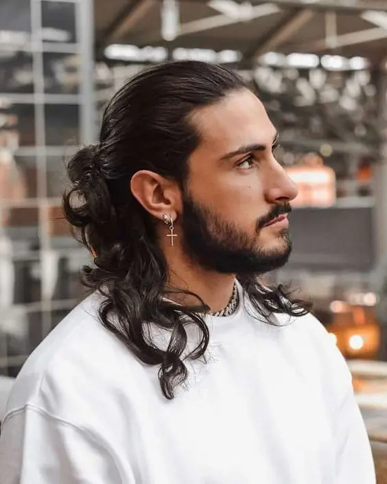 long black wavy hair with a sleek top and a man bun plus a beard are a lovely and chic combo to rock