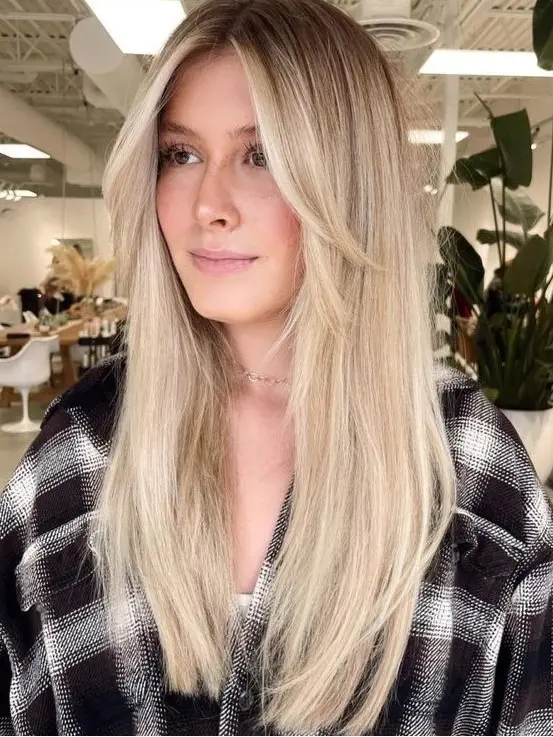 long blonde hair with layers framing the face that add interest to the look and bring dimension to the hairstyle