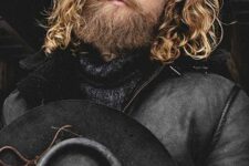long blonde wavy hair plus a full long beard are a cool and chic combo for a Viking-style look