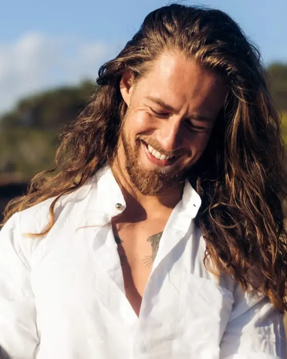 long brunette and golden hour hair with waves, with a slight side sweep paired with a beard looks amazing