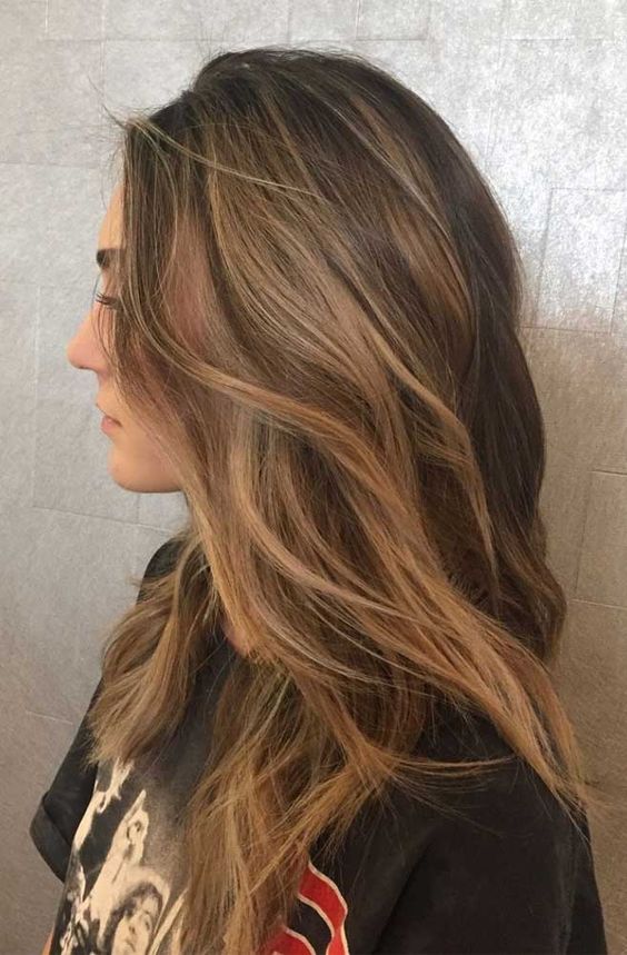 long brunette hair with caramel balayage  and beach waves is a very stylish and cool idea to rock