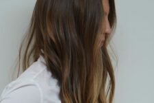 long dark brunette hair with caramel balayage and slight beach waves is a relaxed and cool solution