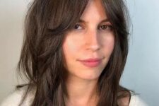long dark brunette hair with layers, mid partition and Bardot-style fringe won’t require much effort to style