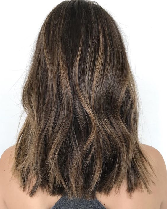 long dark wavy hair with a delicate caramel balayage is a lovely idea that doesn't require much maintenance